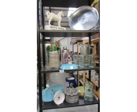 Three shelves of breweryiana including pub memorabilia, Pottery White Horse Scotch whisky ornament, melted bottle ashtray etc