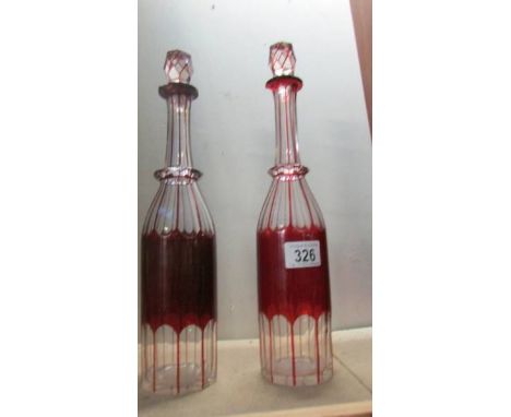 A pair of overlaid ruby cut glass decanters a/f