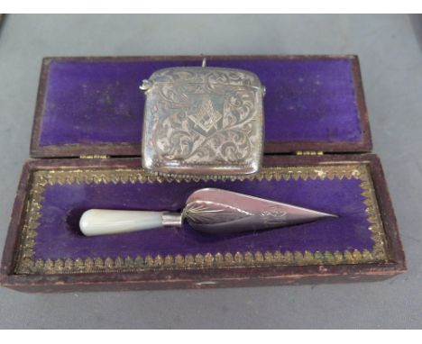 A silver Masonic vesta and a small boxed silver Masonic trowel, a pewter flask and Ronson lighter 