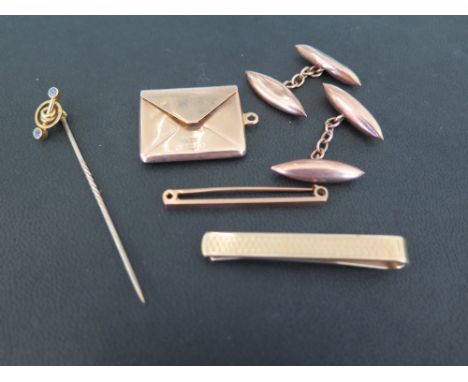 An assortment of items - To include a pair of cufflinks - A tie clip - A stamp holder pendant - A bar brooch - All with marks