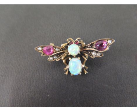 A silver gilt multi-gem bee brooch - Set with opal, garnet, seed pearl and ruby - Stamped 800 - Width 3.3cms - Weight approx 