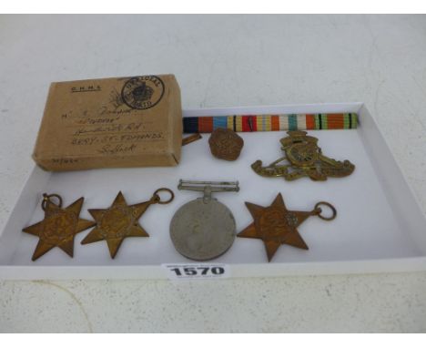 A group of four un-named World War II medals with box and ribbons - M Dobson - a 1st Army ribbon badge and two Artillery badg