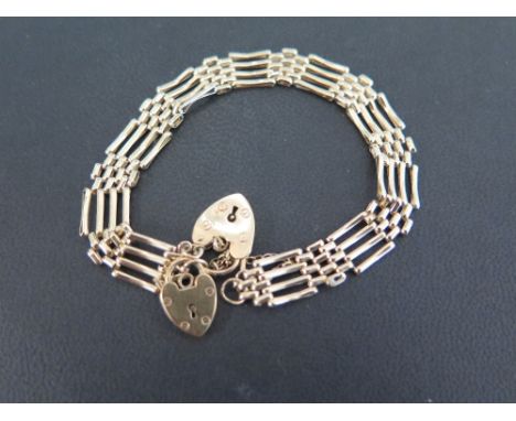 A 9ct gold four-bar gate style bracelet - With two padlock clasps - Hallmarked Birmingham - Length approx 19cms - Weight appr