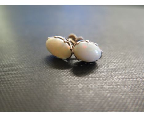 A pair of oval opal cabochon earrings - With screw-back fittings - Tests as 9ct gold - Length 1cm - Weight approx 2.8gms
Cond