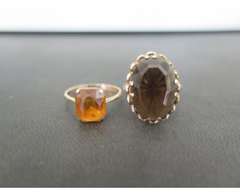 A smokey quartz single-stone ring - Together with an orange-gem ring - Both with marks indicating 9ct gold - Ring sizes Q 1/2