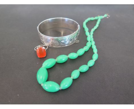 A silver hinged bangle - Hallmarked London - Weight approx 1.7ozt - Together with a green and white bead necklace and an oran