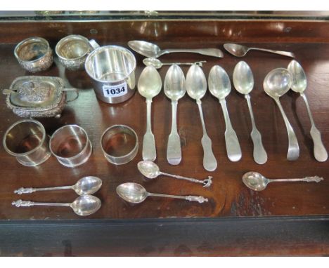 A silver mustard pot and two salts - all without liners, three silver napkin rings, Georgian and later spoons and a small lad