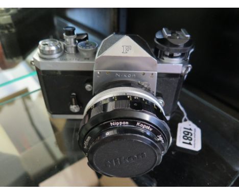 A Nikon F with fast 55 mm 1.2 lens, shutter firing, lens clear and working well, shutter release extension button and flash h