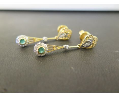 A pair of diamond and emerald ear pendants - Stamped 585 - Length 3.3cms - Weight approx 5.2gms
Condition Report: Good - With