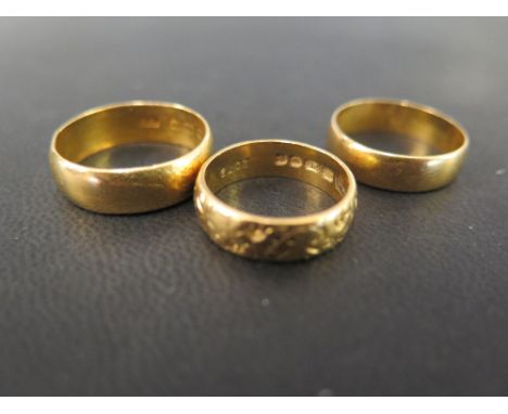 Three 22ct gold band rings - One with textured detail - Hallmarked Birmingham and London - Ring sizes M, Q and S - Weight app