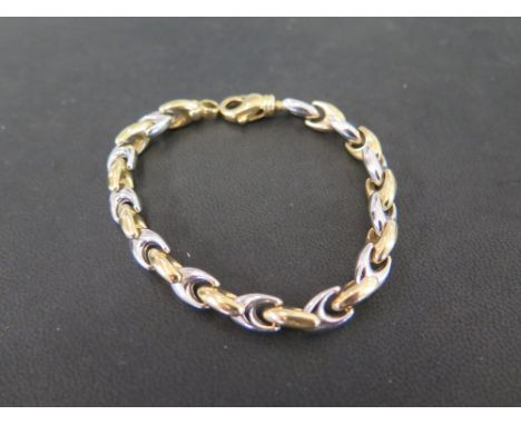 A bi-colour fancy-link bracelet - Stamped 750 - Length 19cms - Weight approx 17.0gms
Condition Report: Good - With light scra