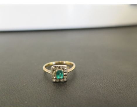 An early 20th century emerald and old-cut diamond cluster ring - To the later band - Tests as high carat gold - Ring size M -