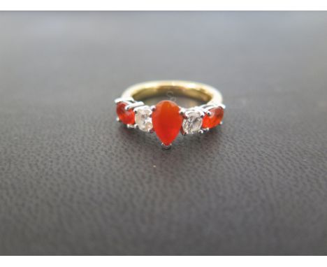 A diamond and fire opal five-stone ring - The pear and oval-shape fire opals to the brilliant-cut diamond spacers - Tests hig