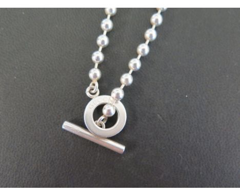 GUCCI  A silver bead necklace - With toggle and circle clasp - Hallmarked London - Length 40cms - Weight approx 26.4gms
Condi