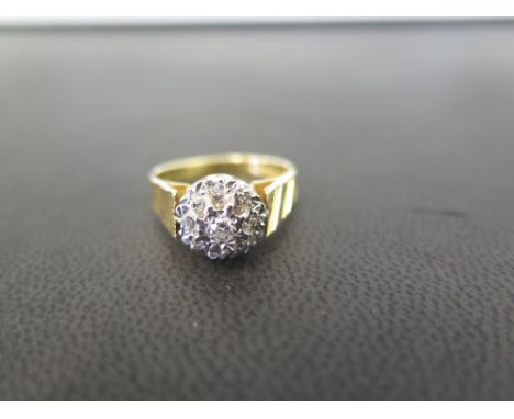 An 18ct gold brilliant and single-cut diamond cluster ring - With grooved line decoration to shoulders - Hallmarked Birmingha