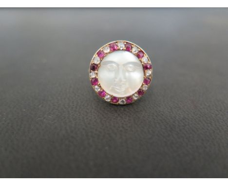 A diamond ruby and rock crystal ring - The circular rock crystal, carved to depict a face within a ruby and diamond surround 