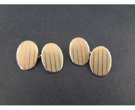 A pair of 9ct gold cufflinks - With textured detail - Weight approx 8.7gms
Condition Report: Good - With light surface scratc