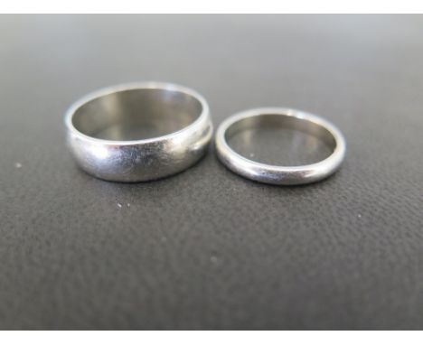 A platinum band ring - Approx 2.5mm - Hallmarked Birmingham - Ring size K - Together with a further band ring- Approx 6mm - S