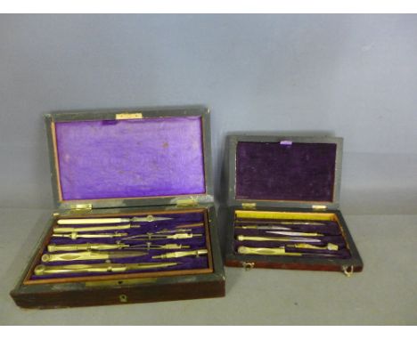 Two boxed Geometry sets - both rosewood cased - large set with ivory handled pen, boxwood rule etc.