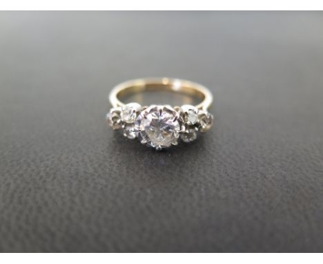 A diamond dress ring - The brilliant-cut diamond within an illusion setting to the vari-cut diamond trefoil shoulders and pla
