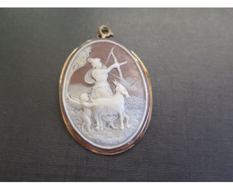 A shell cameo brooch pendant - Depicting Diana The Hunter, a cherub and a goat - Tests as 18ct gold - Length 6cms - Weight ap