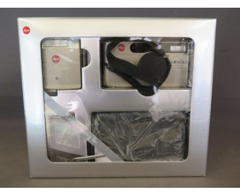 A Leica creative set including camera, flash, case, instruction books and photo album