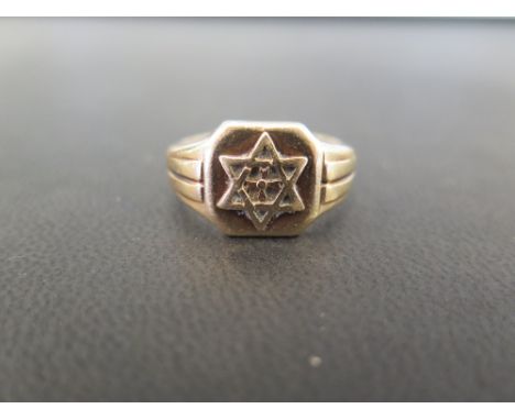 A 9ct gold signet ring - With star detail - Hallmark obscured - Ring size T - Weight approx 7.5gms 
Condition Report: Good to