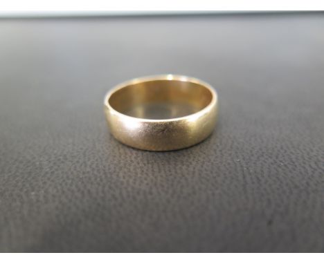 A 9ct gold band ring - Hallmarked London - Width approx 6mm - Weight approx 4.9gms
Condition Report: Good to fair - With ligh