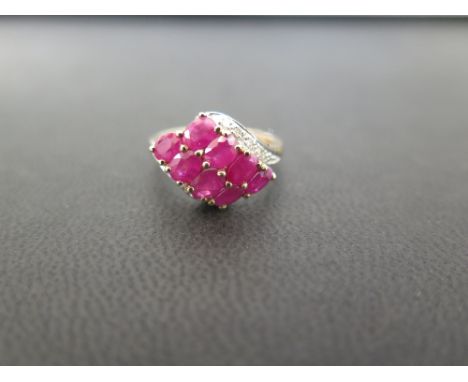 A ruby and diamond dress ring - Hallmarked Birmingham - Ring size K 1/2 - Weight approx 2.5gms
Condition Report: Good - With 