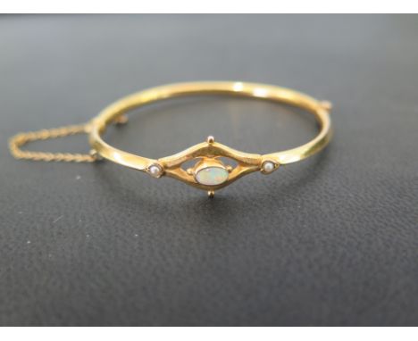 A childs opal and seed pearl hinged bangle - Stamped 9ct - Weight approx 4.7gms
Condition Report: Good - With surface dents a