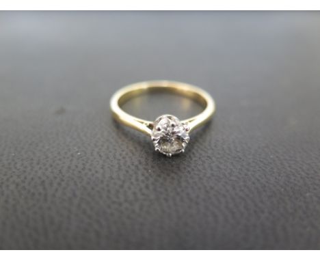 A diamond single-stone ring - The brilliant-cut diamond to the tapered shoulders and plain band - Estimated diamond weight 0.