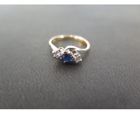 A sapphire and diamond three-stone crossover style ring - Stamped 18ct - Ring size J - Weight approx 2.2gms
Condition Report: