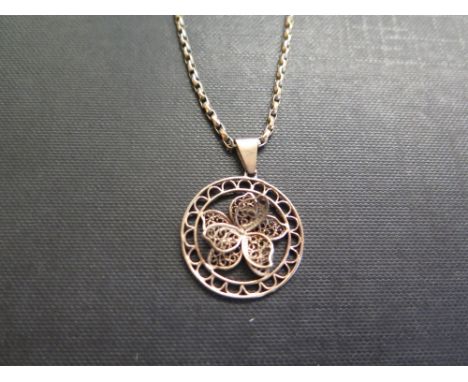 A 9ct gold filigree flower pendant - Partial hallmark - Length 3.5cms - Suspended from a belcher-link chain - Length 53cms - 