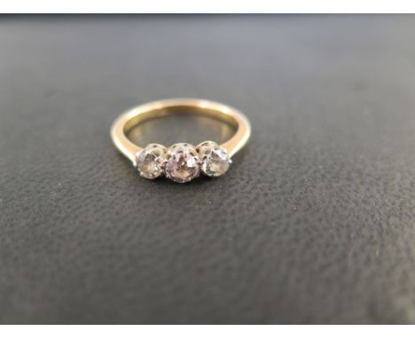 An old-cut diamond three-stone ring - Estimated total diamond weight 0.50ct - Stamped 18ct - Ring size Q - Weight approx 3.4g