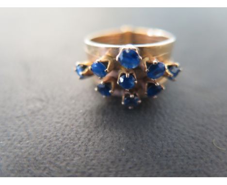 An unusual gold and sapphire five band ring each band set with a claw set sapphire - size K - Weight approx. 69 grms - tests 