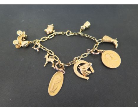 A charm bracelet - Suspending eight assorted charms - Stamped 750 - Length 19cms - Weight approx 27.8gms
Condition Report: Go