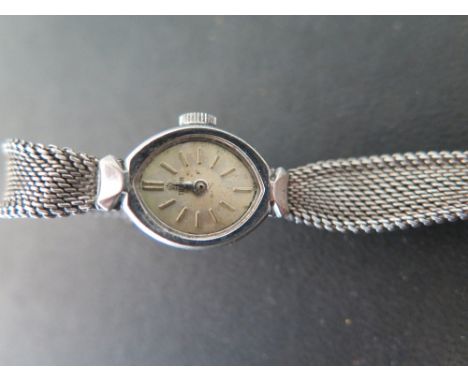 A Ladies steel cased Deco style Tudor wristwatch on a shaped mesh strap, silvered face with baton marker 
Condition report: N