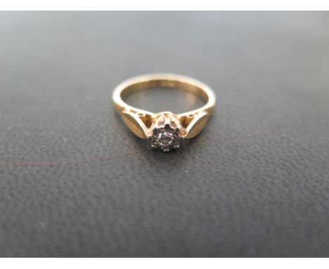 A diamond single-stone ring - The brilliant-cut diamond within an illusion setting to the plain band - Stamped 18ct - Ring si