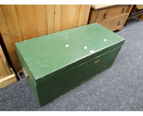 A painted green small wooden trunk with carry handles