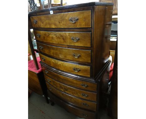 A reproduction Queen Anne-style mahogany bow fronted chest-on-chest