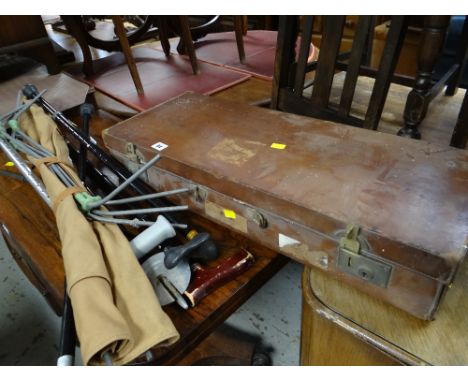 A vintage brown leather carry case, a collection of walking sticks including shooting stick, riding crop etc