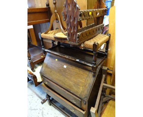 A vintage sloped top two-drawer bureau together with a long rush topped stool, magazine rack, wine tables