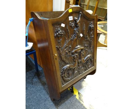 A heavily carved low country single-door hanging wall cabinet with lower shelf