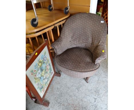 A vintage tub-style bedroom chair together with a tapestry fire screen