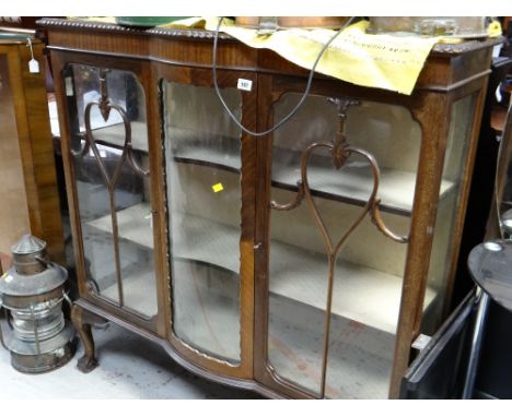 A vintage bow fronted three-section glass door mahogany railback display cabinet on raised ball & claw feet