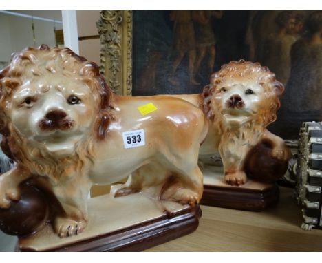A pair of vintage Staffordshire ceramic lions