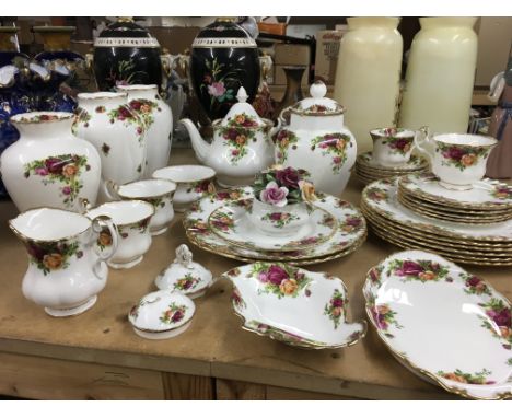 A collection of royal Albert country rose ware including dinner plates vases cups tea plates