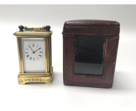 A cased small carriage clock.