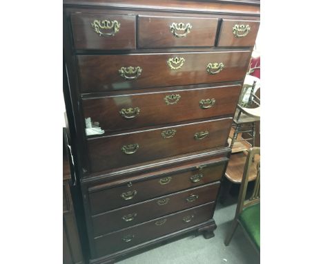 A Georgian mahogany chest on chest fitted with 9 drawers and brushing slide on bracket feet
