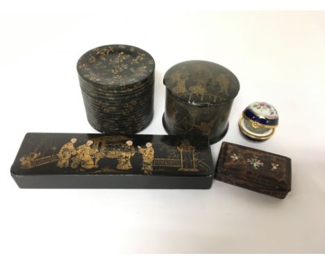 A collection of four boxes, one a snuff box and another containing a bone fan, and a small ceramic container for perfume.